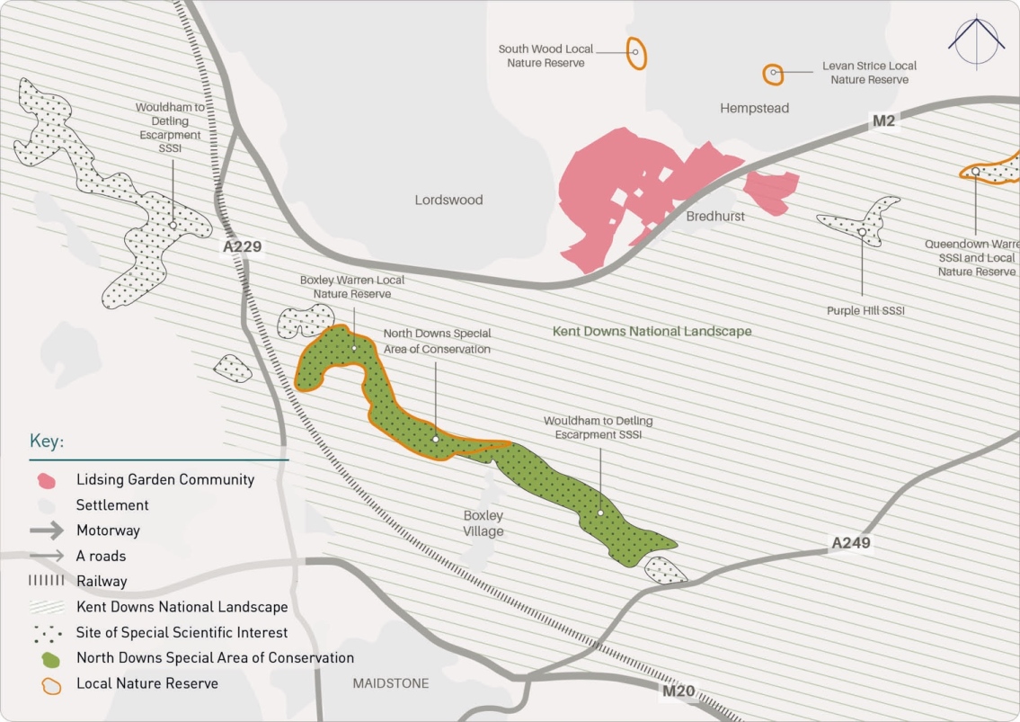 Liding Garden Community in pink, settlement in pink, motorway and roads in gray, railway lines in dotted black, special scientific interest sites in dotted black, conservation areas in green, local nature reserves in orange outlines, the Kent Downs National Landscape in shaded areas, Woodham to Detling Escarpment SSSI along A229, North Downs Special Area of Conservation along railway, Bredhurst, Hempstead, Boxley Village, and Maidstone nearby.