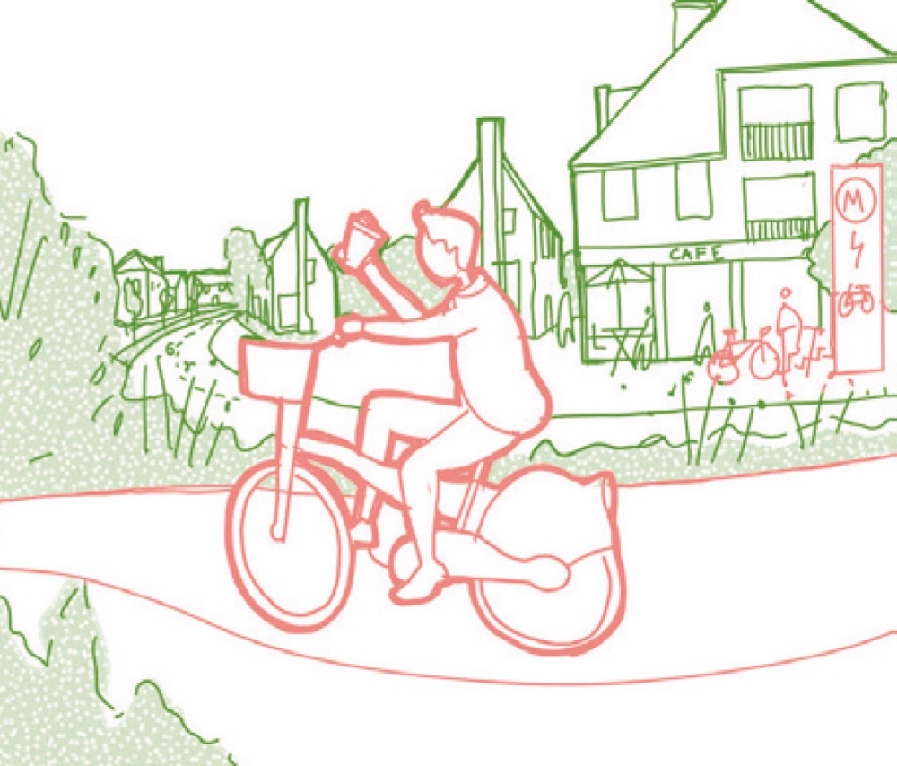 A person riding a bicycle on a street, holding a coffee cup with one hand, with a building labelled "Café" and bicycles parked near a bike rack in the background.